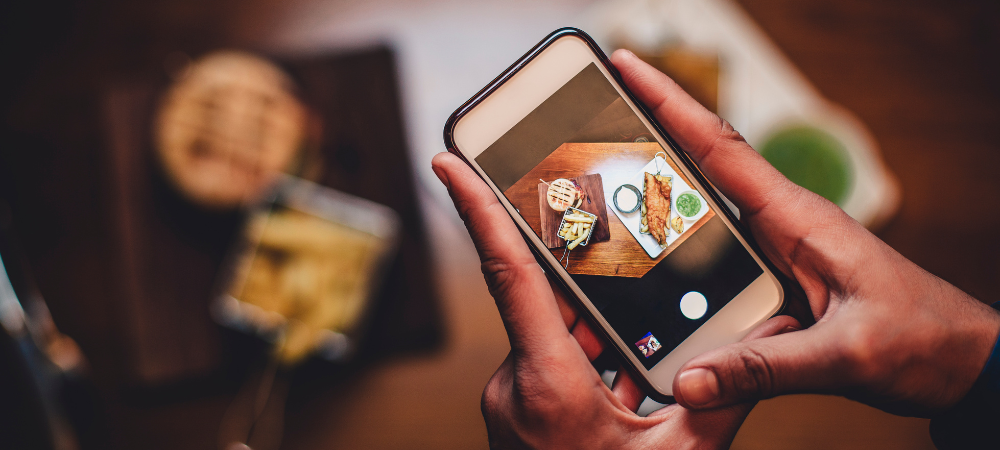 phone taking picture of food on table