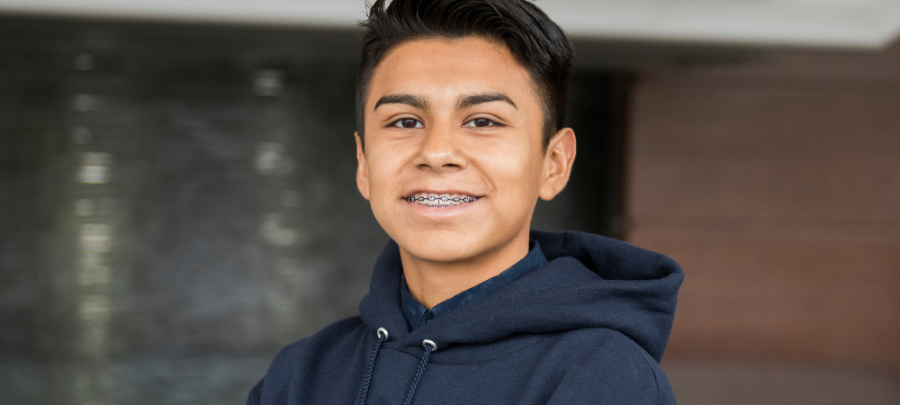 close up of male student wearing blue sweater