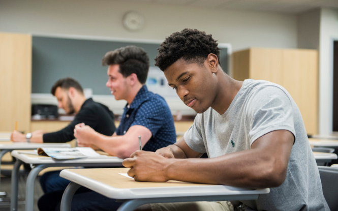 students sitting at desks inside classroom