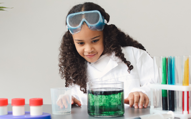 young student wearing safety gear in lab setting